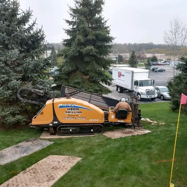 Herr Drilling horizontal directional drilling rig boring beneath a finished lawn without opening a trench